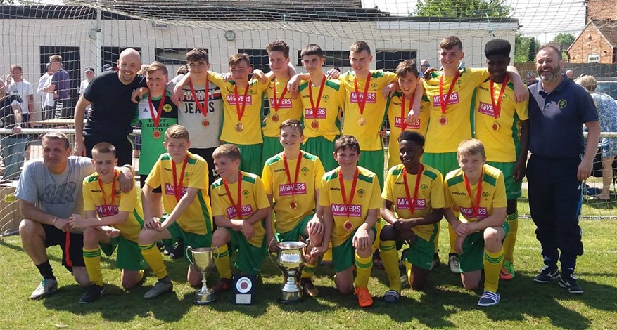 Arden Forest football team players posing in their green and yellow football kit.