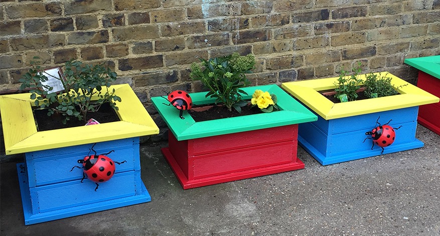 Colourful planters with large ladybird models at Carmel Caterpillars pre-school