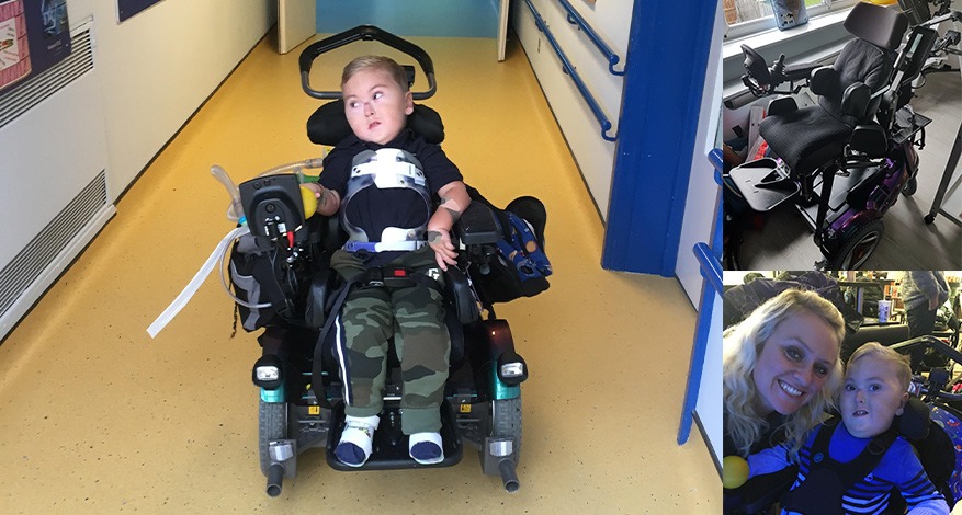 Child sitting in a mobility chair that has been donated to him.