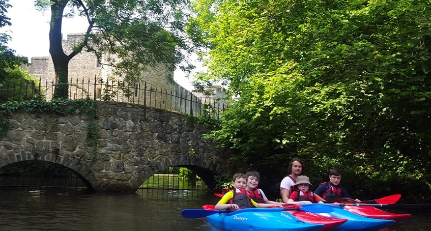 Stepney Scouts and scout leaders kayak down river.