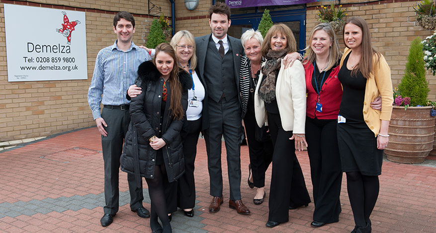 Axis Foundation Trustees and Demelza staff group together outside Demelza office.