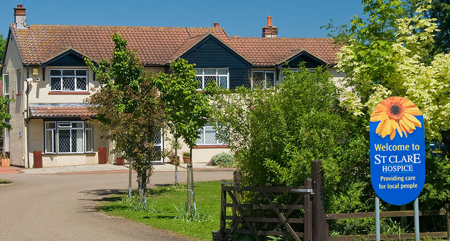 Exterior shot of St Clare Hospice with sign