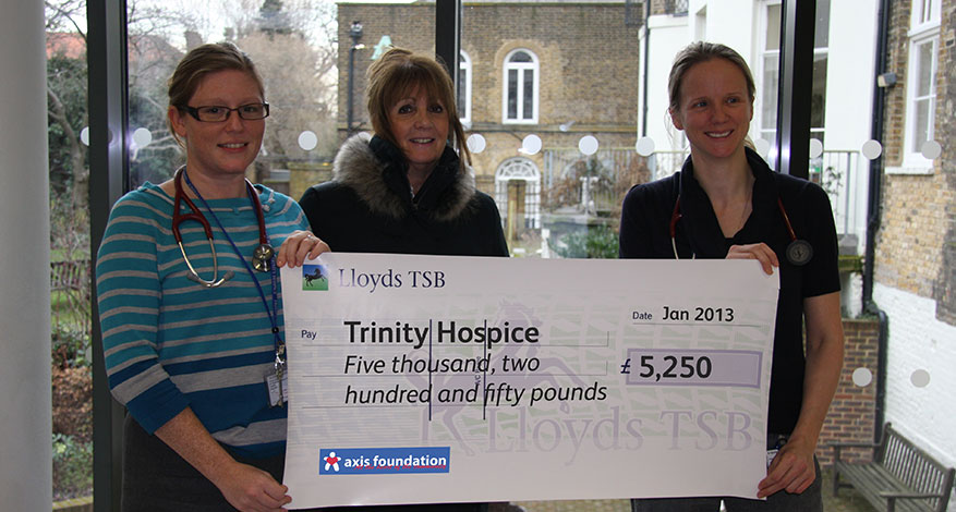 Trustees giving a cheque to the Trinity Hospice.