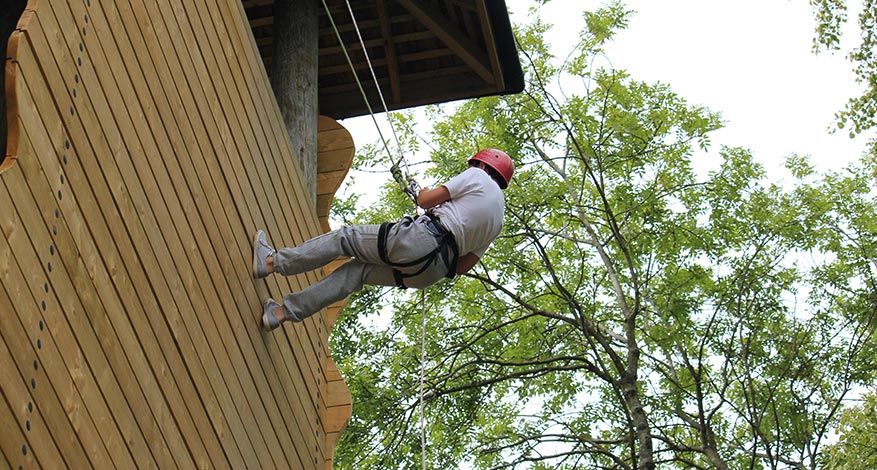 Child abseiling on residential trip with Purley Youth Project