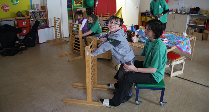 Children playing with carers from the London Centre for Children with Cerebral Palsy