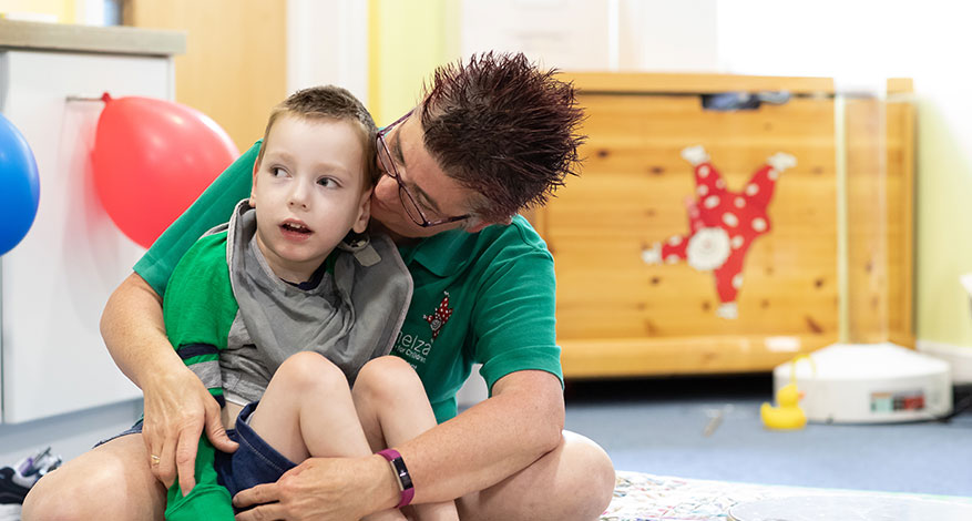 Demelza worker and child at Demelza Hospice Care for Children