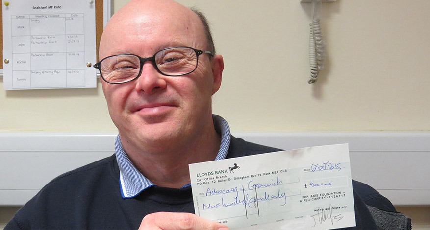 Man holding donation cheque for Singing group