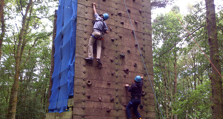 Two children rock climbing at school trip with Quest Specialist School
