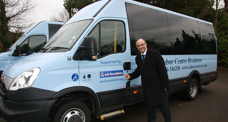 Axis MD Joe Ibrahim hands over new mini bus to the Tabor Centre.