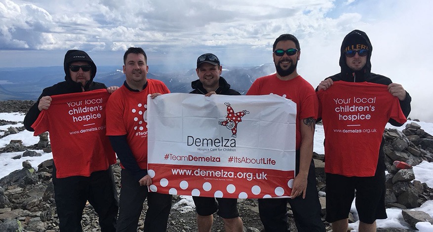 Five Men on summit of Arctic Mountain for Demelza Arctic Challenge Fundraiser