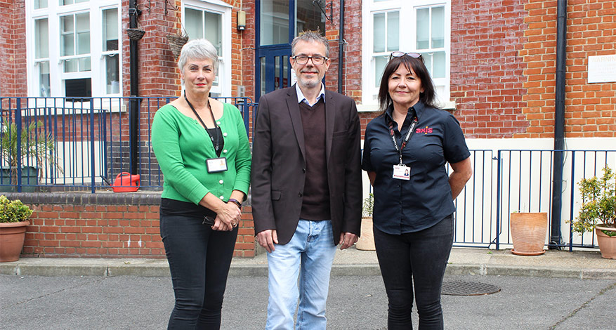 Three people in front of Alcohol and Drug Detoxification Centre with new accessible bathroom