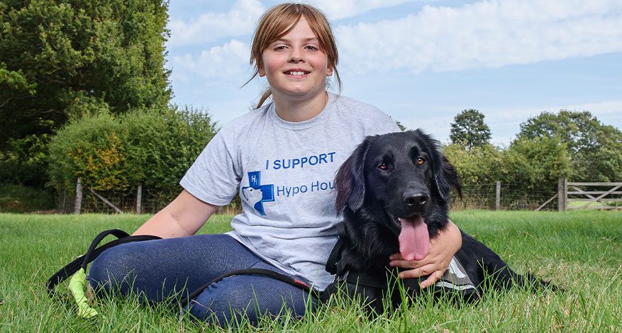 Child in grey Hypo Hounds t-shirt and black dog