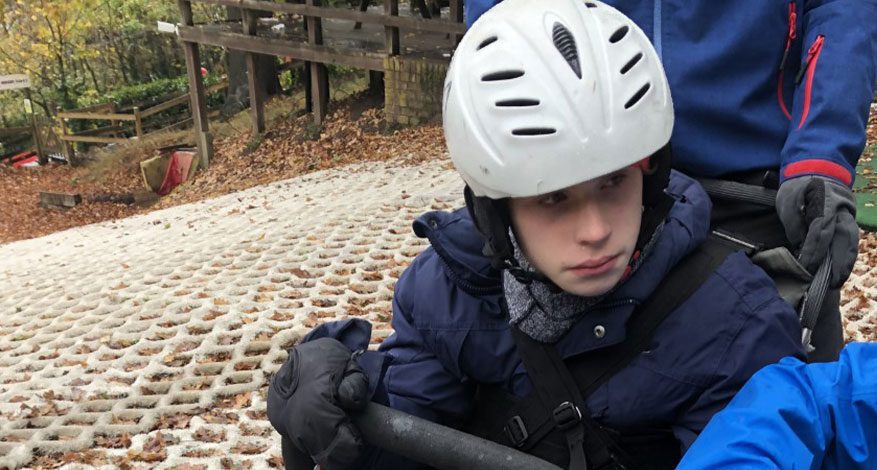 young boy on dry ski slope TAG adaptive snow sports