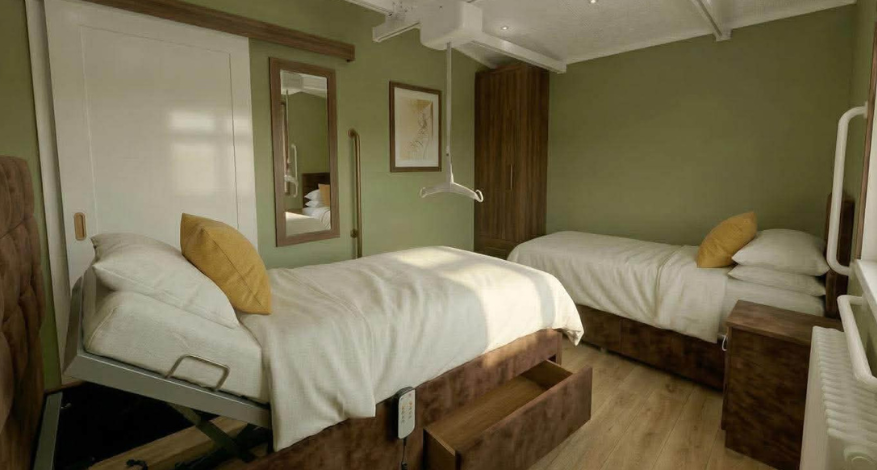 Bedroom with adapted lifting beds and hoist