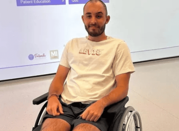 man in white tee shirt and shorts in wheelchair