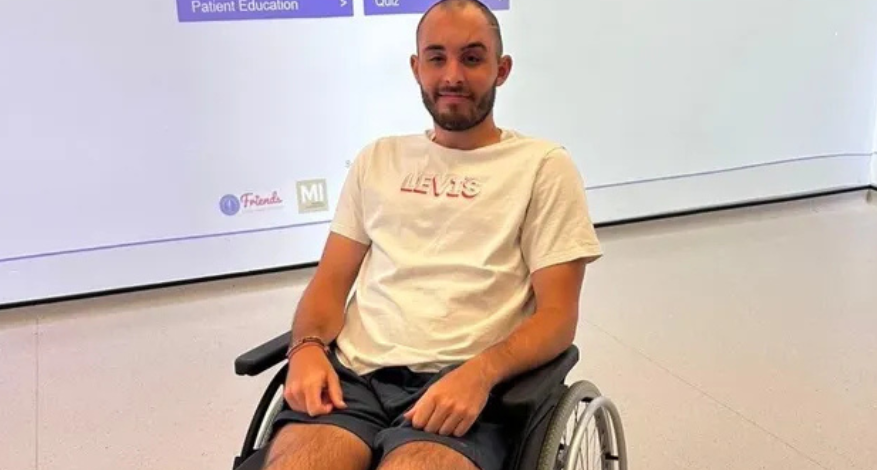 man in white tee shirt and shorts in wheelchair