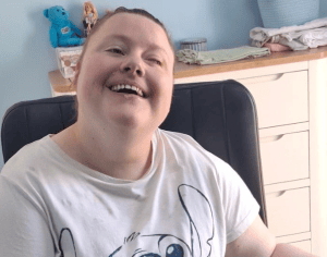 young girl in white teeshirt in wheelchair