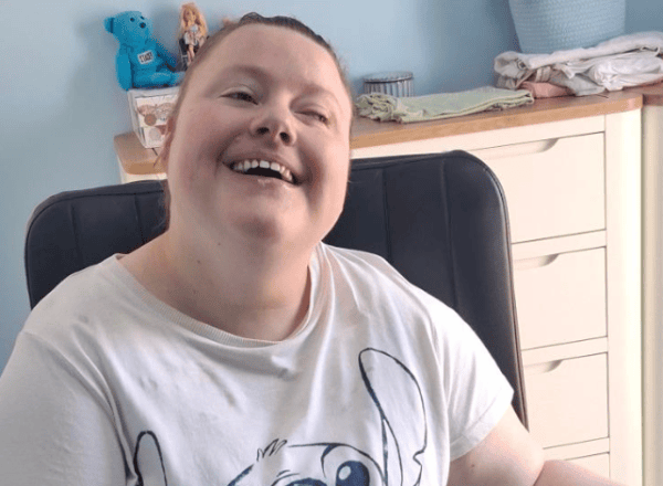 young girl in white teeshirt in wheelchair