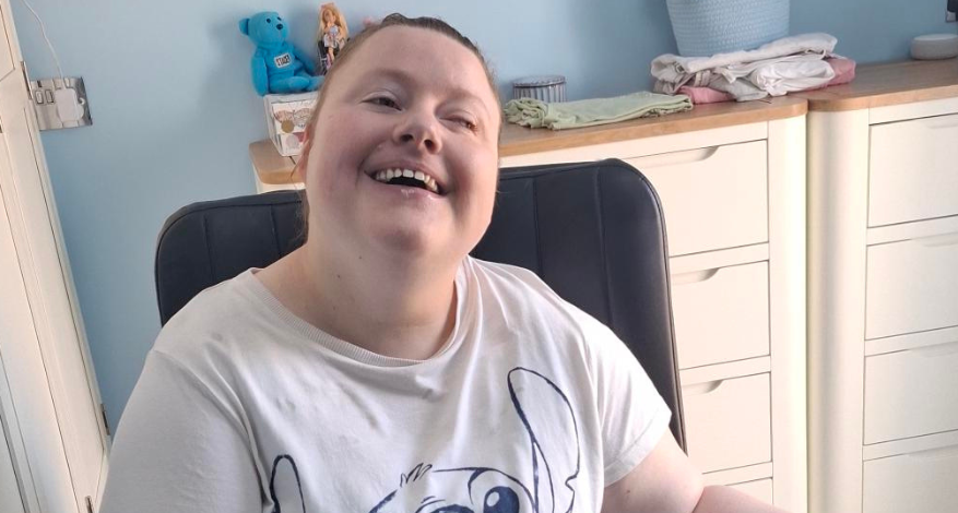 young girl in white teeshirt in wheelchair